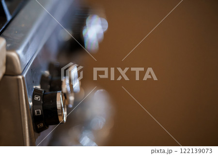 Close-up of a Modern Kitchen Stove's Control Knobs with Soft Bokeh Background Close-up of a Modern Kitchen Stove's Control Knobs with Soft Bokeh Background 122139073