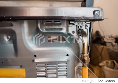 Detailed View of a Gas Connection on a Modern Kitchen Appliance 122139099