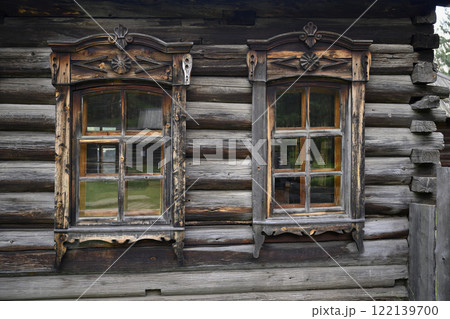 Carved platbands on windows of wooden house built in 1892 in the village of Harety, Siberia, Russia 122139700