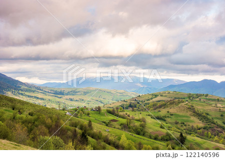 mountain landscape in spring. wonderful distant ridge. countryside scenery with rolling hills. sky with clouds in evening light. amazing springtime mountain landscape in spring. wonderful distant ridge. countryside scenery with rolling hills. sky with clouds in evening light. amazing springtime 122140596