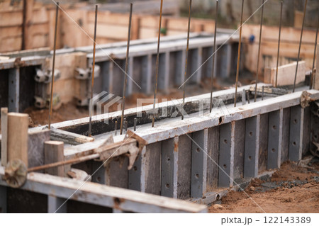 Construction of pile-grillage foundation. Monolithic foundation with metal reinforcement. Monolithic concrete foundation. House construction Construction of pile-grillage foundation. Monolithic foundation with metal reinforcement. Monolithic concrete foundation. House construction 122143389