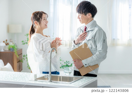 作業服の男性と悩む若い女性 作業服の男性と悩む若い女性 122143806