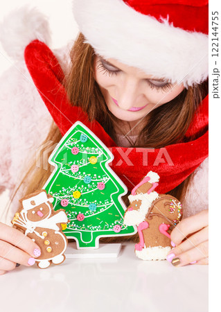 Woman santa claus hat with gingerbread cookies. Christmas Woman santa claus hat with gingerbread cookies. Christmas 122144755