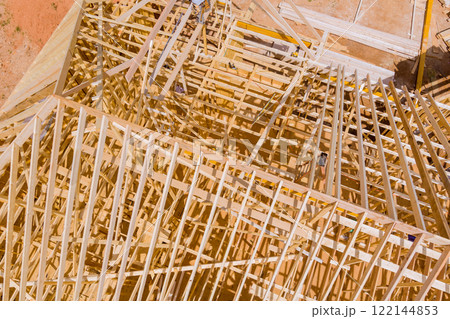 Construction workers collaborate to erect wooden framework new building in construction site 122144853