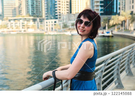 Vacation of a middle-aged woman, a walk along the embankment of a large European city 122145088