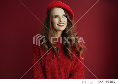 pensive elegant woman in sweater and beret on background 122145463