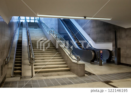 There is a set of stairs accompanied by escalators located within a building 122146195