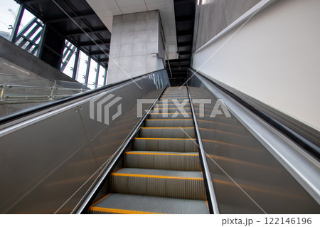 An escalator featuring bright yellow steps that move both upward and downward 122146196