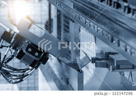 High technology bending machine operation with robotic system in the light blue scene. High technology bending machine operation with robotic system in the light blue scene. 122147298