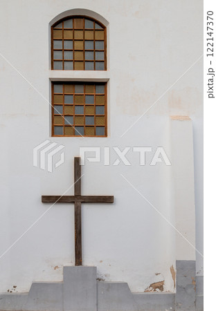 White wall of a church and a cross, Haria, Spain White wall of a church and a cross, Haria, Spain 122147370