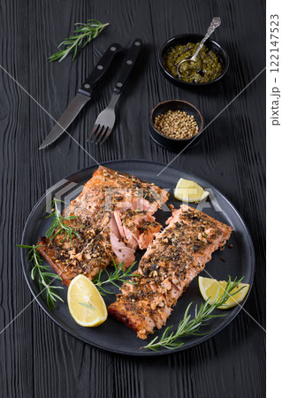 baked salmon fillet with lemon, rosemary on plate baked salmon fillet with lemon, rosemary on plate 122147523