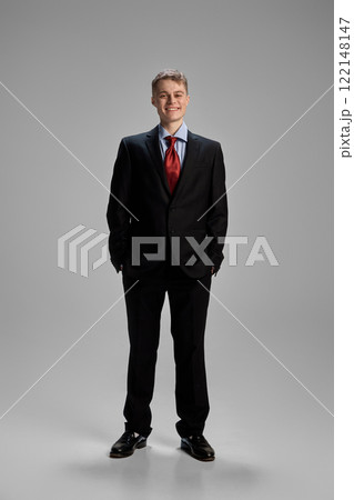 Man standing with hands in pockets, maintaining poised and relaxed stance, exuding self-assured composure and projecting professional confidence Man standing with hands in pockets, maintaining poised and relaxed stance, exuding self-assured composure and projecting professional confidence 122148147