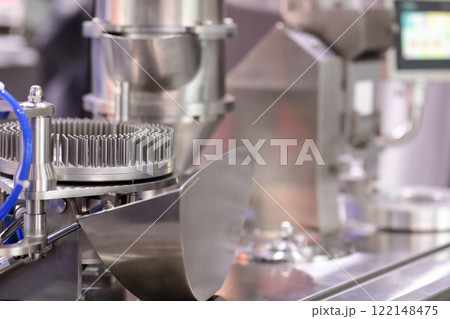 automatic capsule manufacturing machine close up 122148475
