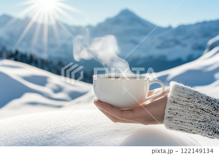 Hand Holding Tea Cup Against Snow-Covered Mountains. Sunlight Highlighting Steam Rising From Hot Drink. Tranquil And Refreshing Winter Scene. AI generated Hand Holding Tea Cup Against Snow-Covered Mountains. Sunlight Highlighting Steam Rising From Hot Drink. Tranquil And Refreshing Winter Scene. AI generated 122149134