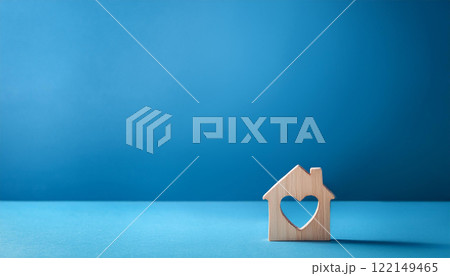 Wooden House with Heart Shaped Cutout on Blue Background Wooden House with Heart Shaped Cutout on Blue Background 122149465