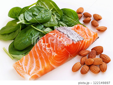 Well balanced diet with salmon and fresh spinach with raw almond nuts on light background.Macro.AI Generative. 122149897