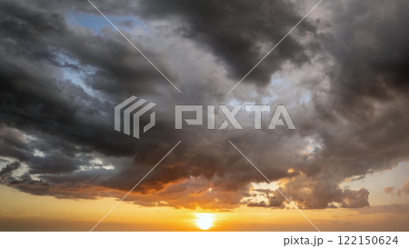 Beautiful sunset sky scenery. Bright colorful orange and yellow clouds on horizon Beautiful sunset sky scenery. Bright colorful orange and yellow clouds on horizon 122150624