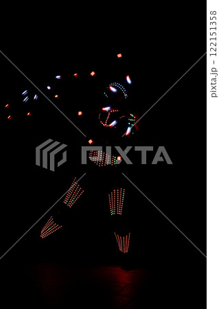 Led dancer performing in the dark with light emitting suit and gloves 122151358