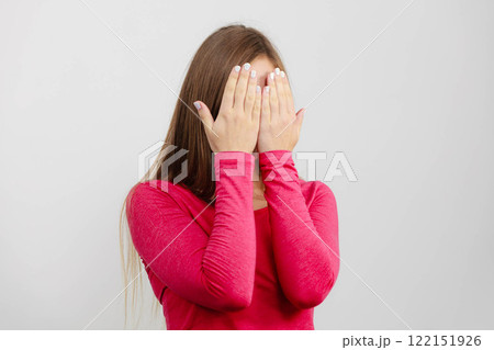 Shy girl hides her face 122151926