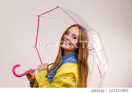 Woman wearing waterproof coat under umbrella 122151967