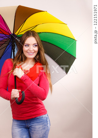 Woman standing under multicolored umbrella 122151971