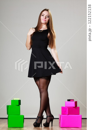 Elegant woman with many gift boxes 122152138