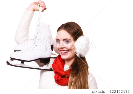 Woman with earmuffs and ice skates. Woman with earmuffs and ice skates. 122152153