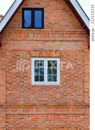 Building made of brick facade with beautiful white wooden windows. 122152232