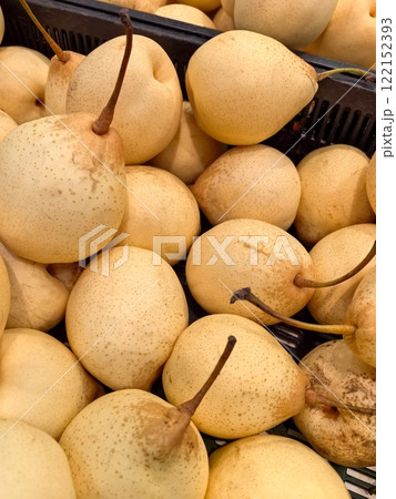Golden pears in a vibrant market display inviting taste and freshness Golden pears in a vibrant market display inviting taste and freshness 122152393