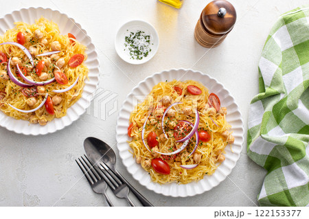 Spaghetti squash with chickpeas and tomatoes topped with red onion, low carb vegan recipe idea Spaghetti squash with chickpeas and tomatoes topped with red onion, low carb vegan recipe idea 122153377