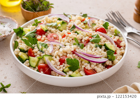Pearl couscous salad with fresh vegetables and red onion Pearl couscous salad with fresh vegetables and red onion 122153420