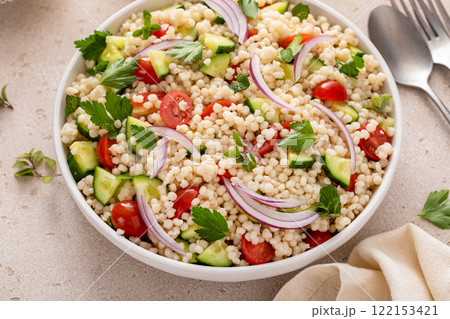 Pearl couscous salad with fresh vegetables and red onion Pearl couscous salad with fresh vegetables and red onion 122153421