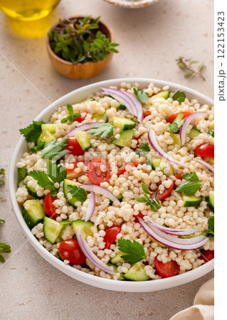 Pearl couscous salad with fresh vegetables and red onion Pearl couscous salad with fresh vegetables and red onion 122153423