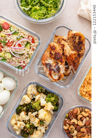 Healthy meal prep with grilled chicken, eggs, lentils, roasted vegetables, nuts and salad 122153440