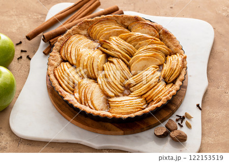 Apple pie or tart filled with sliced apples arranged on a pie base 122153519
