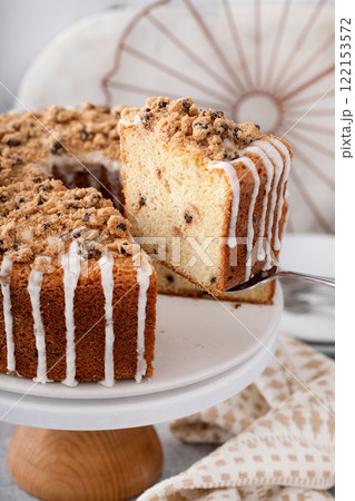 Delicious crumb cake with icing on plate 122153572
