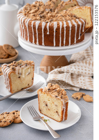 Delicious crumb cake with icing on plate 122153576