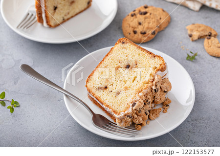 Delicious crumb cake with icing on plate 122153577