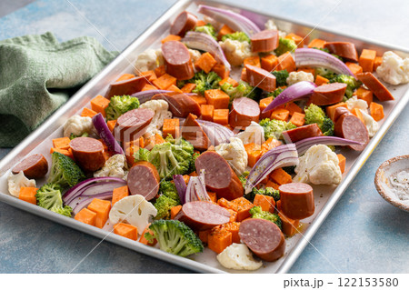 Sheet pan dinner with sausage and vegetables ready to be roasted Sheet pan dinner with sausage and vegetables ready to be roasted 122153580