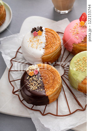 Round croissants with filling and glaze, trendy dessert Round croissants with filling and glaze, trendy dessert 122153744
