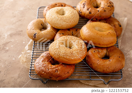 Freshly baked bagels ready to eat for breakfast, sesame, cinnamon and plain Freshly baked bagels ready to eat for breakfast, sesame, cinnamon and plain 122153752