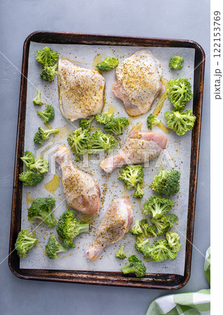 Chicken drumsticks and thighs with broccoli sheet pan dinner or lunch 122153769