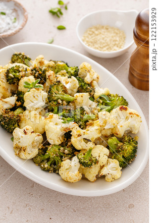 Roasted cauliflower and broccoli on a serving plate, healthy vegetable side dish 122153929