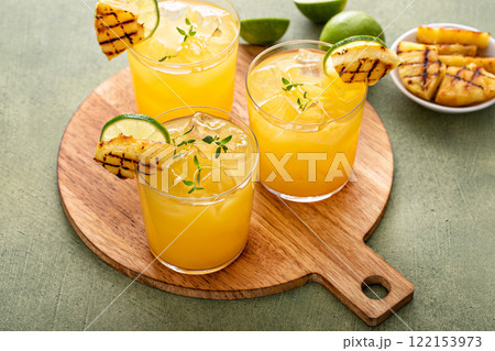 Grilled pineapple margarita with lime on a serving tray 122153973