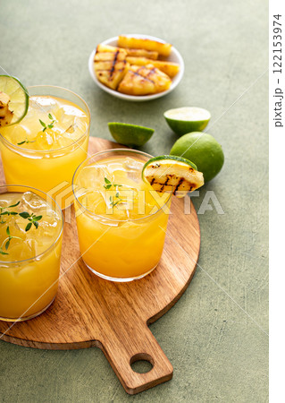 Grilled pineapple margarita with lime on a serving tray 122153974