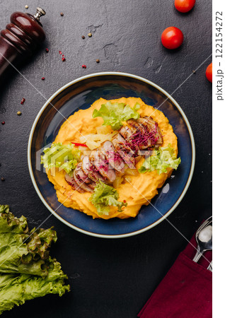 Grilled chicken with mashed potatoes and fresh greens for a wholesome, gourmet meal 122154272