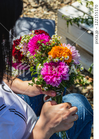 Creating a vibrant floral bouquet in a sunny garden on a joyful afternoon Creating a vibrant floral bouquet in a sunny garden on a joyful afternoon 122155170