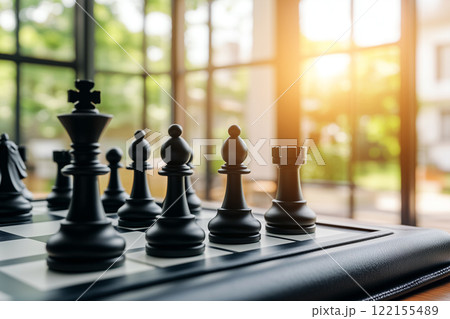 Elegant Chess Setup with Black Pieces on a Table Against a Beautiful Natural Background Elegant Chess Setup with Black Pieces on a Table Against a Beautiful Natural Background 122155489