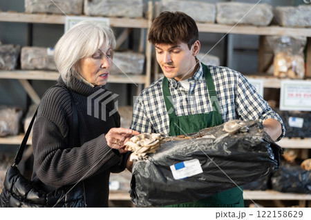 Guy consultant seller, presents mycelium to senior female buyer Guy consultant seller, presents mycelium to senior female buyer 122158629