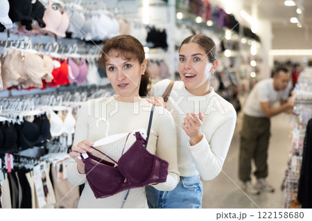 Two women choosing convenient bra in clothing store 122158680